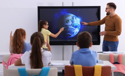 teacher teaching with smart board min